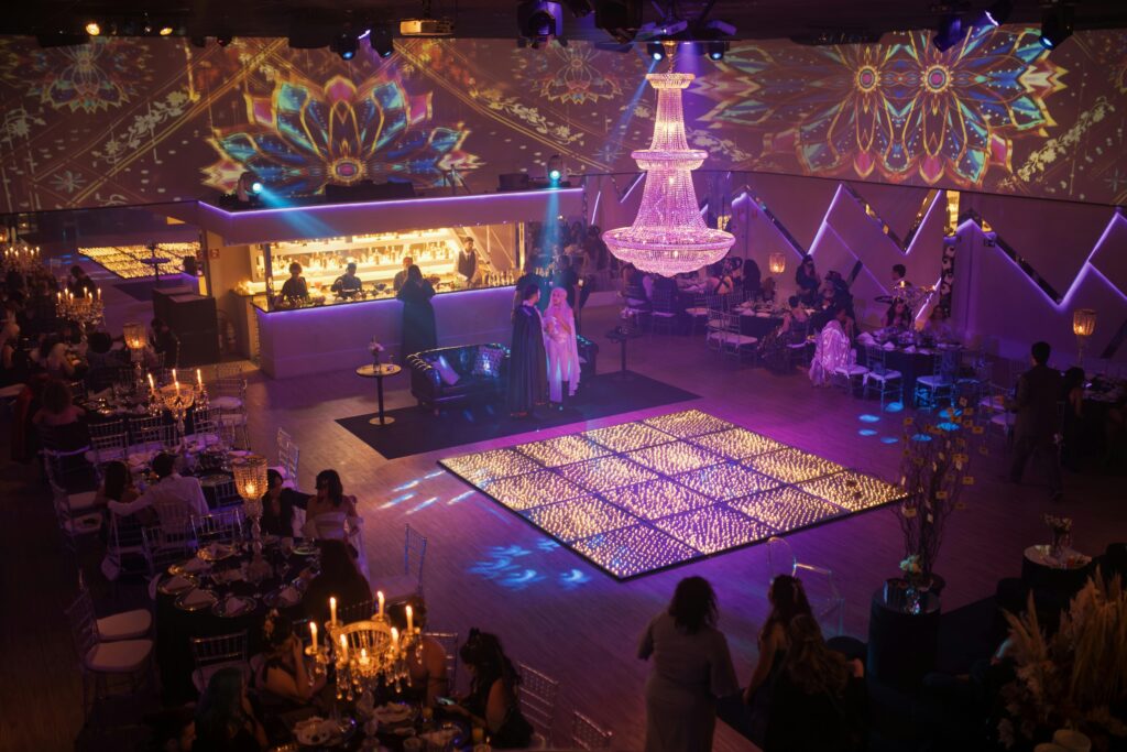 Elegant indoor party with vibrant lighting and luxurious decor, capturing a festive atmosphere.